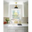 Primary Schoolhouse Pendant Light, 997-Natural Raw Brass, Small Opaque Glass, Single Painted Band, 100-Black | Photo Courtesy of Melissa Maria and Architectural Digest