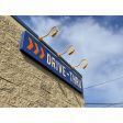 Bullet Gooseneck LED Sign Light, 570-Sunflower, G22 Gooseneck Arm, LED12- Up to 1200 Lumens, 3000K - Neutral White, No Optics - 90 Degree Flood, Frosted Glass | Photo Courtesy of Water Street Coffee Joint