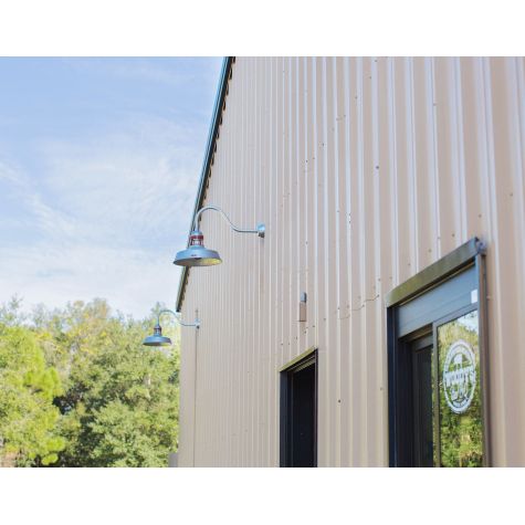 (2) 16" Sydney Gooseneck Lights, 975-Galvanized Finish, G22 Gooseneck Arms in 975-Galvanized, No Cap, 400-Barn Red Guard Finish, Decorative Backing Plate Cover in 975-Galvanized | Photo Courtesy of Woody's Bar-B-Q in Cocoa, Florida