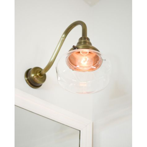Primary Schoolhouse Gooseneck Light, 998-Natural Weathered Brass, Small Clear Glass, No Painted Band, G11 Gooseneck Arm, Brass Backing Plate & Hex Cover | Photo Courtesy of Celebrity Style Guide