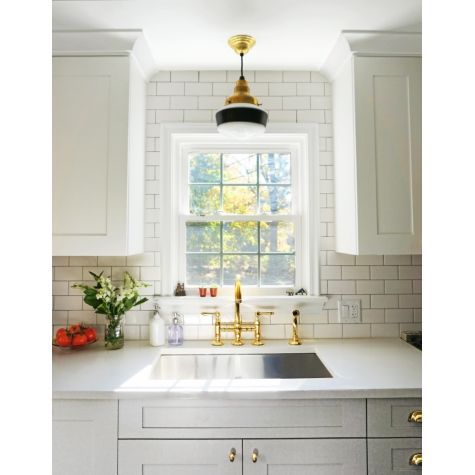 Primary Schoolhouse Pendant Light, 997-Natural Raw Brass, Small Opaque Glass, Single Painted Band, 100-Black | Photo Courtesy of Melissa Maria and Architectural Digest