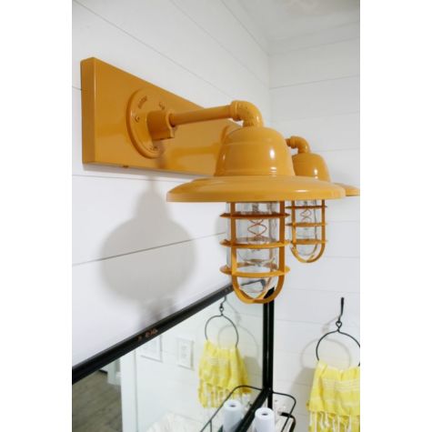 Industrial Guard Double Vanity Light, 570-Sunflower, CGG-Standard Cast Guard, CLR-Clear Glass | Photo Courtesy of Lolly Jane