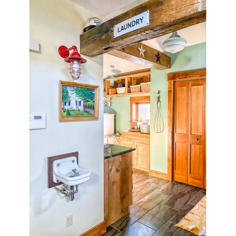 Industrial Guard Sconce, 400-Barn Red, WGG-Wire Guard, CLR-Clear Glass (Also Pictured: Porcelain Enamel LAUNDRY Sign, Primary Schoolhouse Stem Mount Pendant, and Industrial Guard Pendant Light) | Photo Courtesy of April Hershberger (@barnhomeliving)