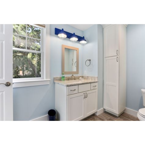Austin Triple Straight Arm Vanity Light, 700-Royal Blue, 8” Wire Cages in 975-Galvanized | Courtesy of Coastal Custom Home Builders