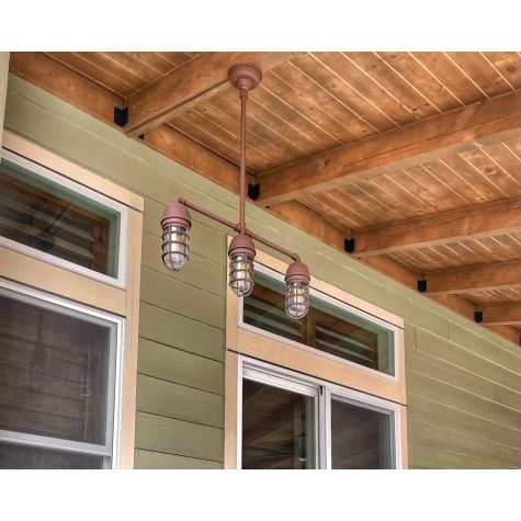 Alliance 3-Light Chandelier, 605-Rust, 24" Stem Hang Straight, CGG-Standard Cast Guard, 605-Rust, Clear Glass | Photo Courtesy of Homeowner